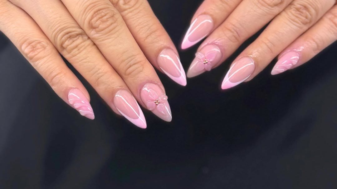 Pink French-tip almond nails with 3D flower art from Blossom Nail & Spa